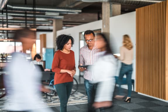 partenaires commerciaux suivant le financement sur une tablette numérique dans un bureau occupé